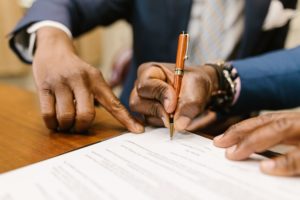Men signing agreement: Financing Your Business: Essential Funding Strategies