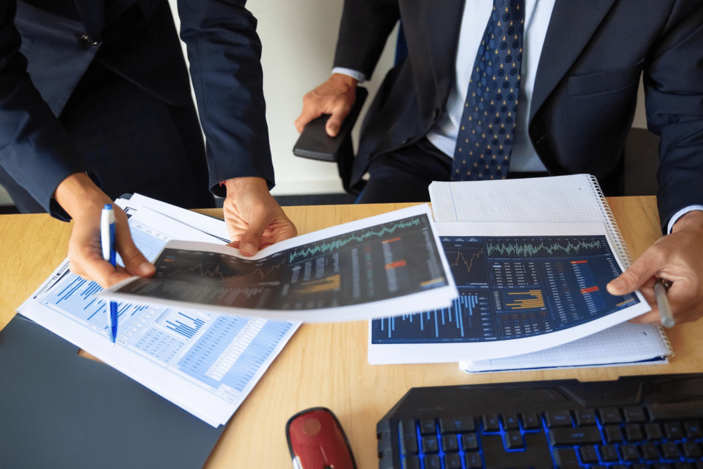 Business professionals review financial reports in a meeting